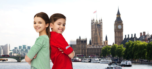 Image showing happy boy and girl standing together over london