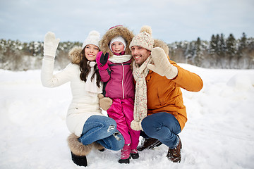 Image showing happy family waving hands outdoors in winter