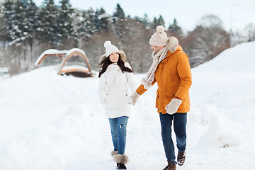 Image showing happy couple walking over winter background