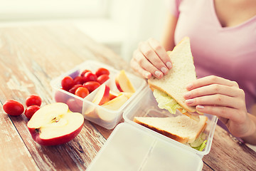 Image showing close up of woman with food in plastic container