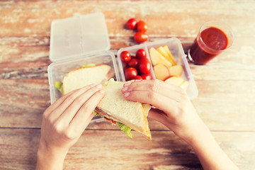 Image showing close up of woman with food in plastic container