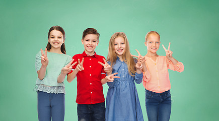 Image showing happy boy and girls showing peace hand sign