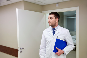 Image showing doctor with clipboard at hospital corridor
