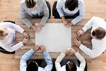 Image showing close up of business team sitting at table