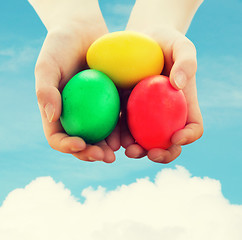 Image showing close up of kid hands holding colored eggs