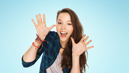 Image showing happy laughing pretty teenage girl showing hands