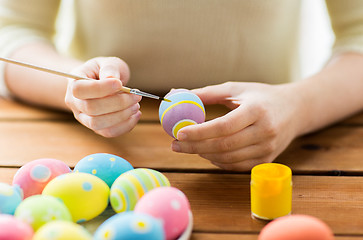 Image showing close up of woman hands coloring easter eggs