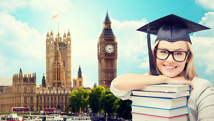 Image showing student in trencher cap with books over london