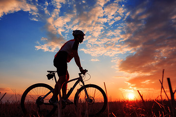 Image showing mountain biker silhouette in sunrise