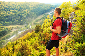 Image showing Men walk along the hill with backpack