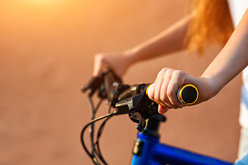 Image showing teenage girl and bike in city