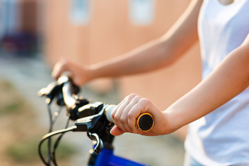 Image showing teenage girl and bike in city