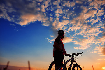 Image showing Man Cyclist with bike on sunset