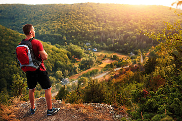 Image showing Men walk along the hill with backpack