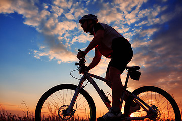 Image showing mountain biker silhouette in sunrise