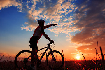 Image showing mountain biker silhouette in sunrise