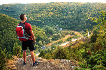 Image showing Men walk along the hill with backpack