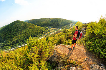 Image showing Men walk along the hill with backpack