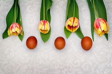 Image showing Three Easter eggs and tulips.