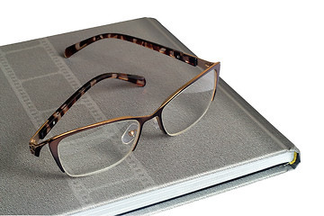 Image showing Glasses and notebook on a white background.