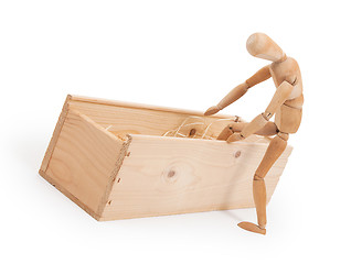 Image showing Wood figure mannequin stepping in a wooden box