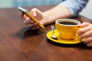 Image showing close up of woman with smartphone and coffee