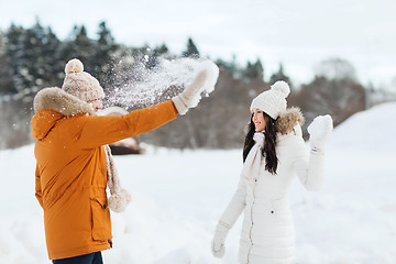 Image showing happy couple playing with snow in winter