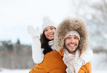 Image showing happy couple having fun over winter background