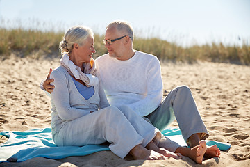 Image showing happy senior couple hugging on summer beach