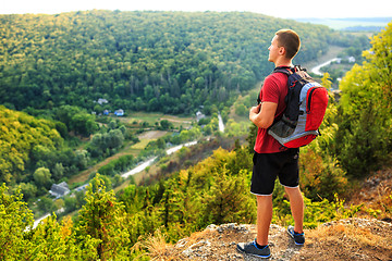 Image showing Men walk along the hill with backpack