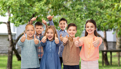 Image showing happy children showing thumbs up over backyard