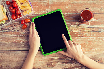 Image showing close up of woman with tablet pc food on table