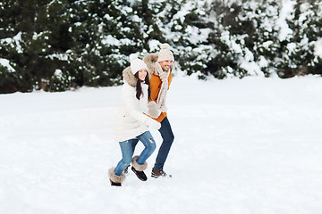 Image showing happy couple running over winter background