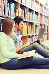 Image showing happy students with laptop in library