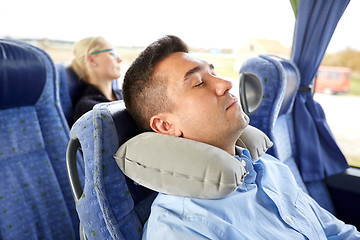 Image showing man sleeping in travel bus with cervical pillow