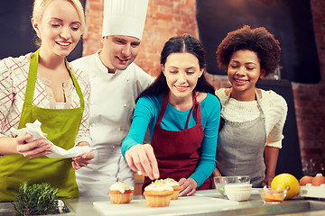 Image showing happy women and chef cook baking in kitchen