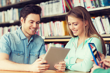 Image showing happy students with tablet pc in library