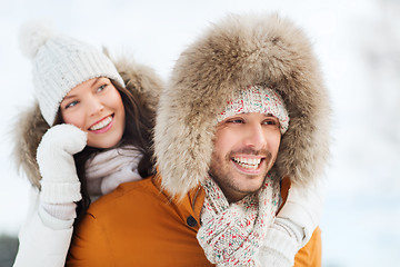 Image showing happy couple having fun over winter background