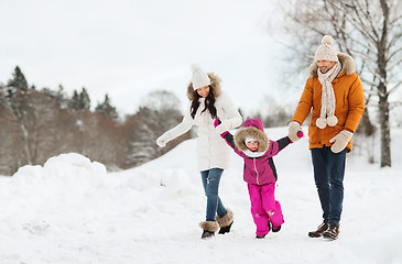 Image showing happy family in winter clothes walking outdoors