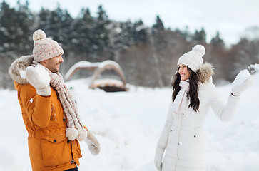 Image showing happy couple playing snowballs in winter