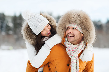 Image showing happy couple having fun over winter background