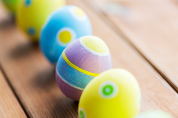 Image showing close up of colored easter eggs on wooden surface