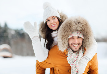 Image showing happy couple having fun over winter background