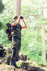 Image showing soldier with binocular and backpack in forest