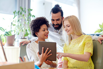 Image showing happy creative team with tablet pc in office