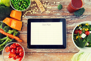 Image showing close up of diet plan on tablet pc and vegetables