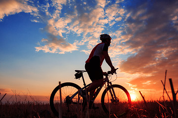 Image showing mountain biker silhouette in sunrise