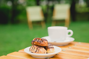 Image showing Morning coffee. Cup coffee in park