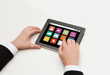 Image showing close up of man hands with app icons on tablet pc