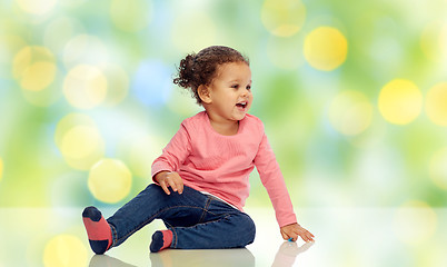 Image showing smiling little baby girl sitting on floor